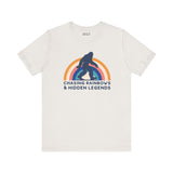 Chasing Rainbows and Hidden Legends tee featuring a Sasquatch graphic and vibrant rainbow design, perfect for PNW pride.