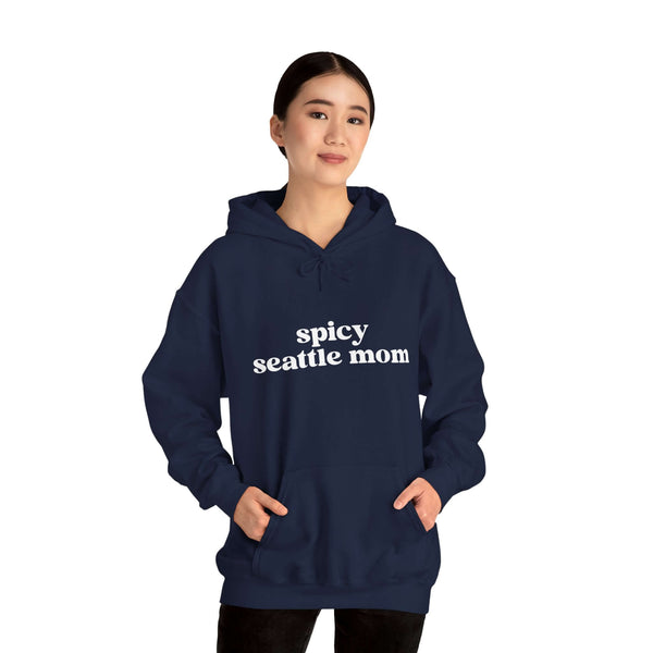 Woman wearing a Spicy Seattle Mom hoodie, showcasing bold style and cozy comfort for trendy Seattle moms.