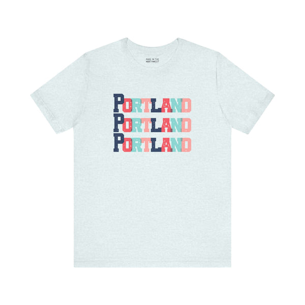 "Bold and Bright Portland Trio Soft Tee with colorful block-letter design on light background"