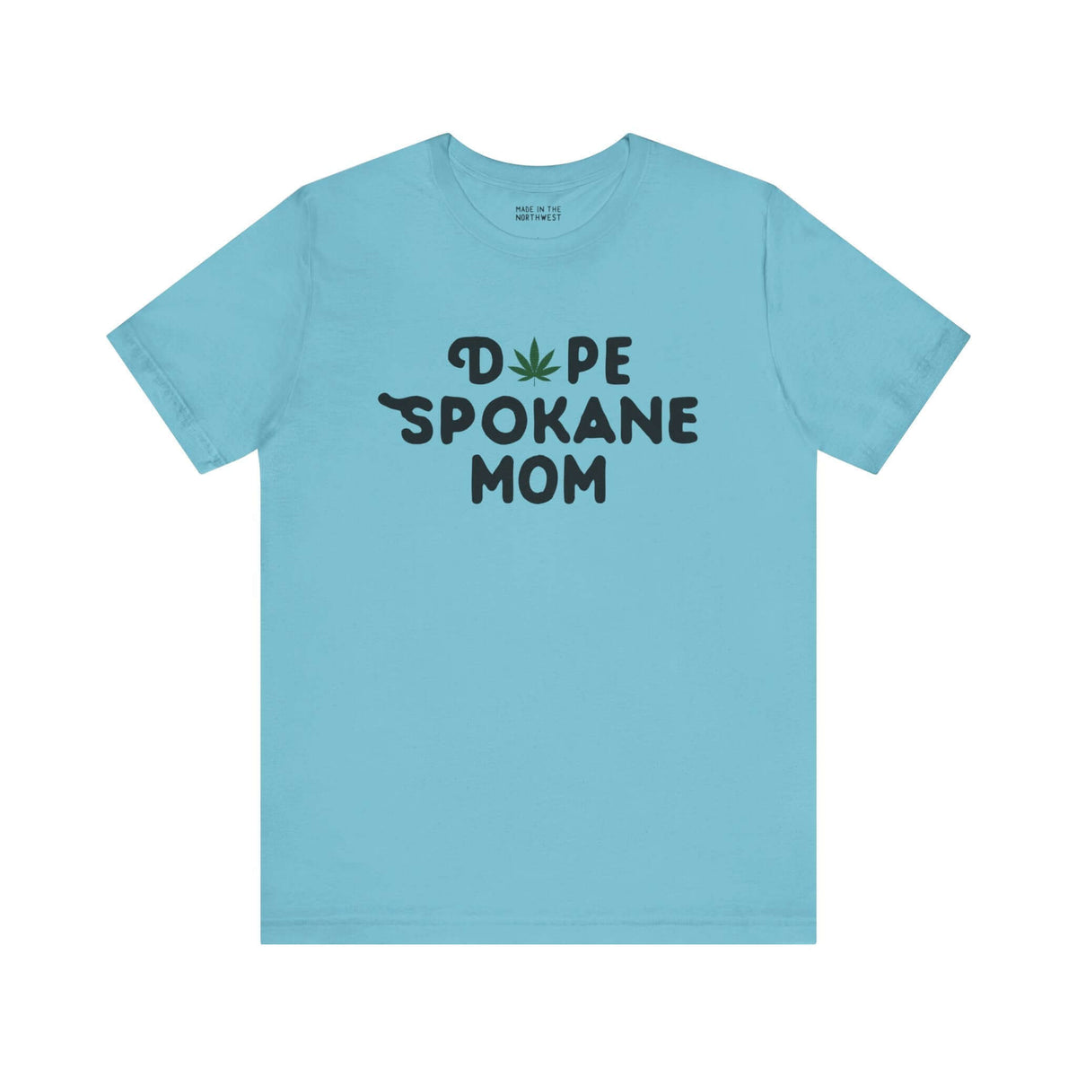 Light blue tee with "Dope Spokane Mom" text, featuring a marijuana leaf replacing the "O" in "Dope."