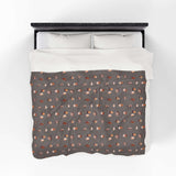The Daily Grind Coffee Lovers Lightweight Cozy Blanket featuring coffee designs on a warm, cozy fabric.