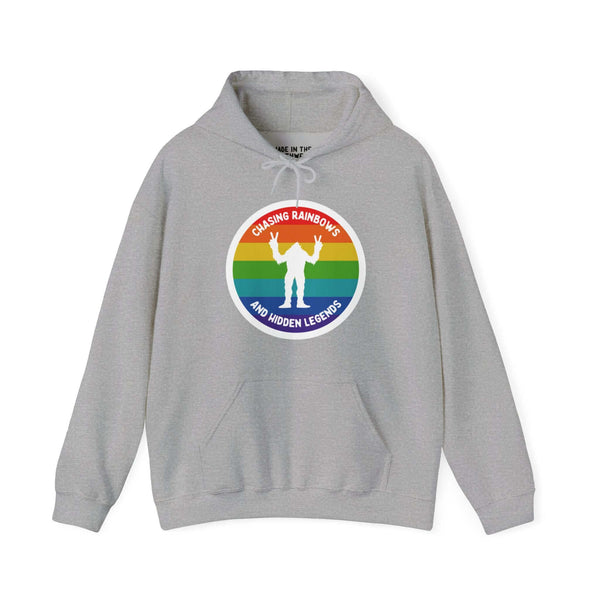 Gray Sasquatch hoodie with rainbow circle and "Chasing Rainbows and Hidden Legends" text, celebrating PNW spirit.