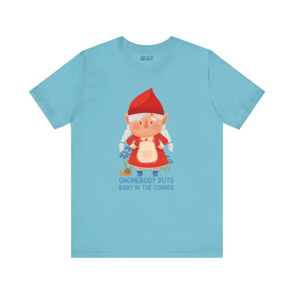 Light blue tee with a cute female gnome and "Gnomebody Puts Baby in the Corner" text, humorous and whimsical design.