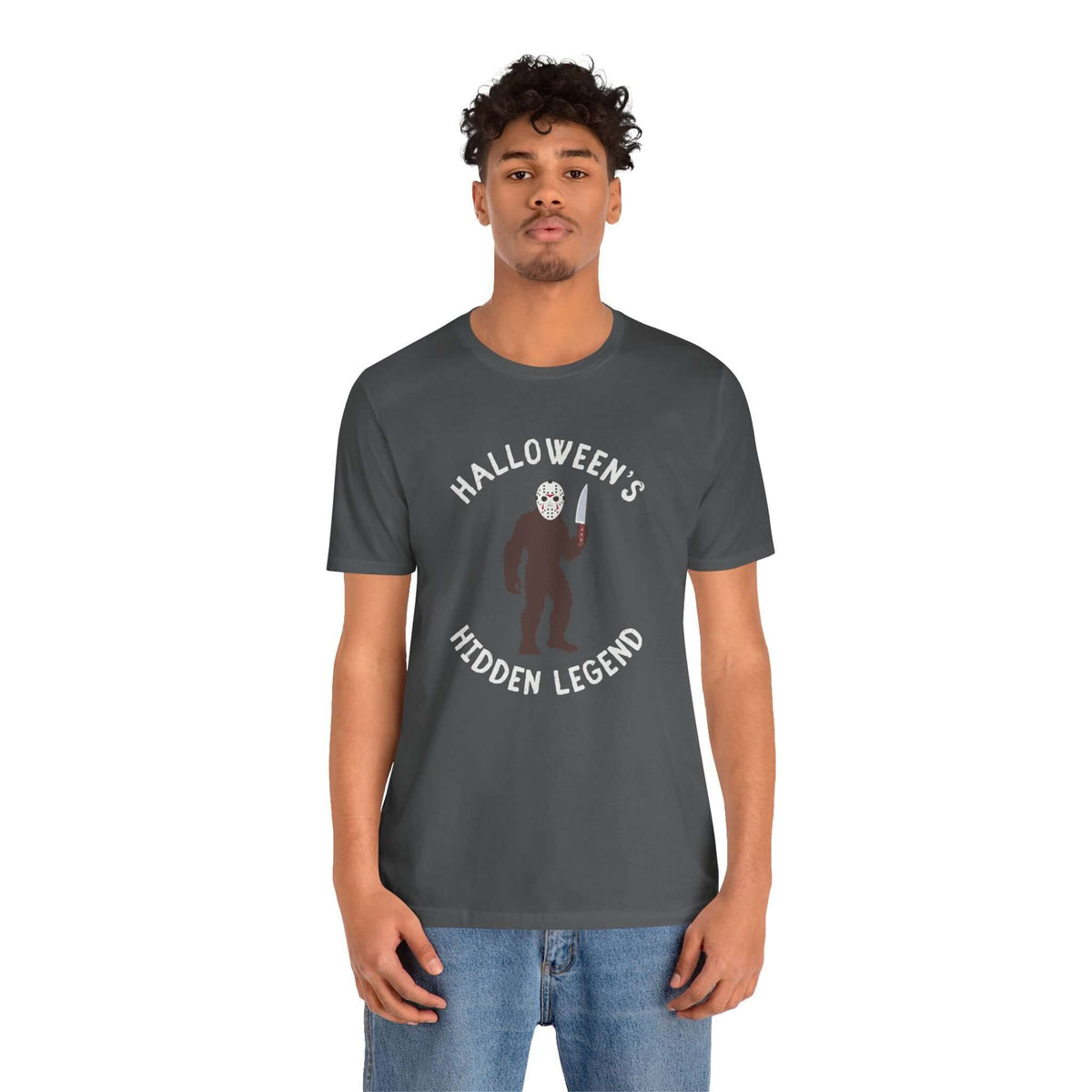 Halloween's Hidden Legend Bigfoot tee featuring Sasquatch dressed as Jason with a knife for spooky season.