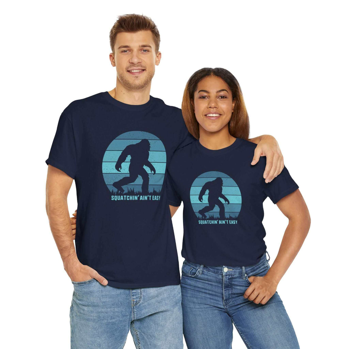 Two people wearing 'Squatchin' Ain't Easy' Bigfoot tees, showcasing playful Sasquatch hunting design, perfect for Bigfoot enthusiasts.