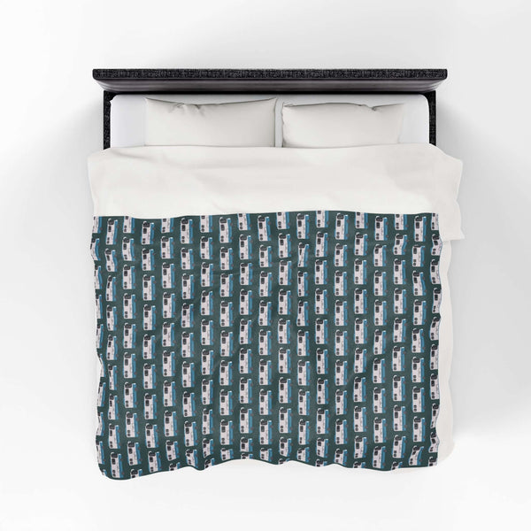 Highway Hideaway Class A Motorhome Lightweight Cozy Blanket on a bed, featuring a pattern of motorhomes.
