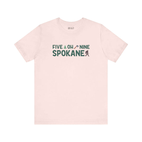 "Five Oh Nine Spokane tee with axe and tree design, showcasing city pride in a stylish soft shirt"