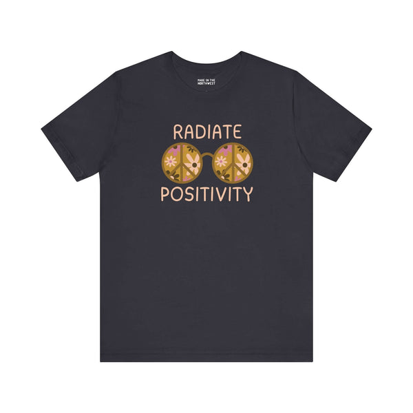 Black premium tee featuring vibrant 'Radiate Positivity' design with floral glasses, perfect for spreading good vibes.