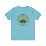 Minimalist Forest in Northwest style tee with mountain print on light blue fabric. Perfect for nature lovers and adventure seekers.