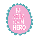 Be Your Own Hero Mug design featuring a pink badge with teal scallops and hand-lettered text.