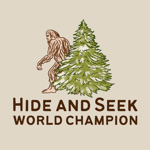 Bigfoot hiding behind a tree in the design for Hide and Seek World Champion T-Shirt.