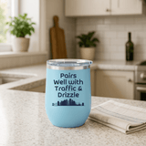 Pairs Well with Traffic and Drizzle Portland PNW Wine Tumbler 12 oz on a kitchen counter with a towel.
