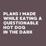 Spiral notebook cover featuring text about plans made while eating a questionable hot dog in the dark.