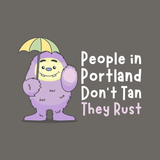 Playful Purple People Eater holding an umbrella, with the text 'People in Portland Don't Tan, They Rust'.