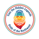 Colorful Bigfoot graphic with text 'Visit the Hidden Legends, Pride of the Northwest' for athletic tee.