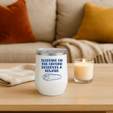 Sleeping on the Ground Deserves a Reward Camping Wine Tumbler 12 oz on a table beside a candle.