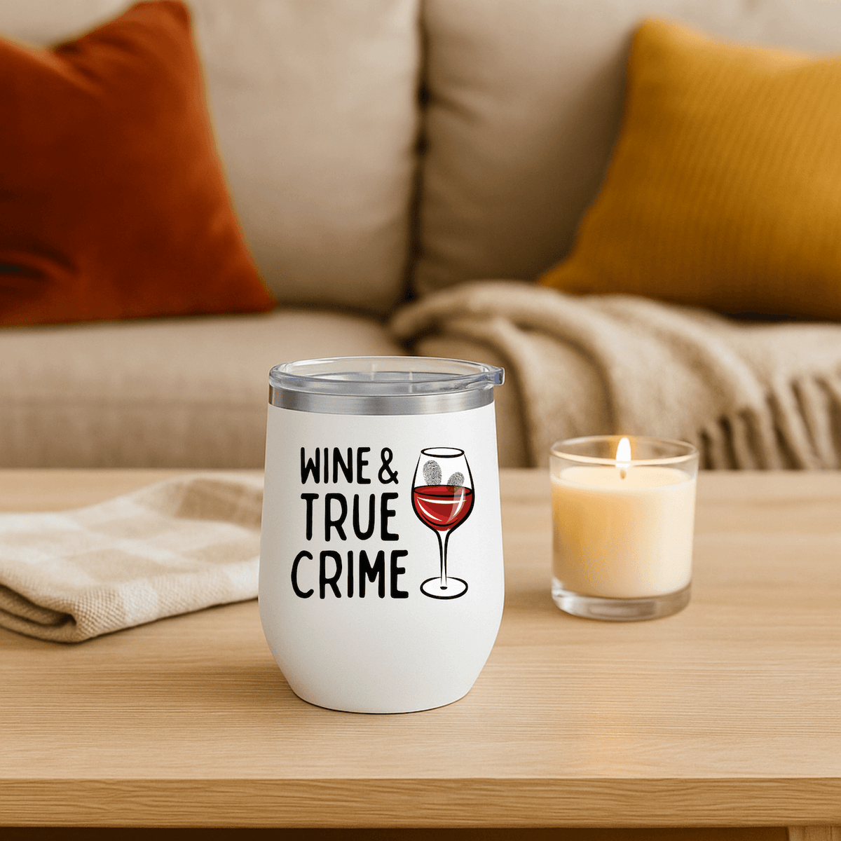 Wine and True Crime Couch Detective Wine Tumbler 12 oz on a wooden table with a candle and cozy decor.