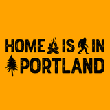Home Is in Portland design featuring illustrations of a tree, campfire, and Bigfoot on a bright orange background.