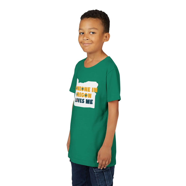 Someone in Oregon Loves Me Premium Soft Kids Tee modeled by a child, featuring a green shirt design.
