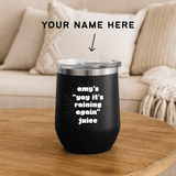 It's Raining Again Juice Personalized PNW Wine Tumbler 12 oz on a wooden table in a cozy setting.